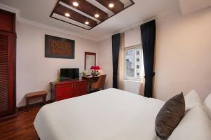 a bedroom with a white bed and a window at Bonjour D' An Nam Home in Hanoi