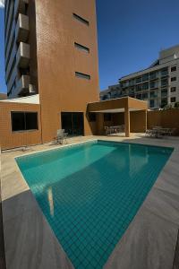 a swimming pool in front of a building at Apartamento em João Pessoa - Frente Pro Mar in João Pessoa