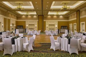 a banquet hall with white tables and white chairs at MeadowView Marriott Conference Resort and Convention Center in Kingsport +90 photos