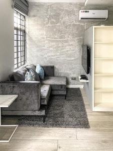 a living room with a couch and a tv at Zen Studio Apt Lekki 1 in Ilado