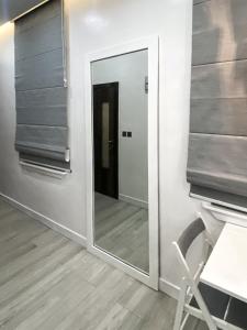 a mirror in a room with a chair and a table at Zen Studio Apt Lekki 1 in Ilado