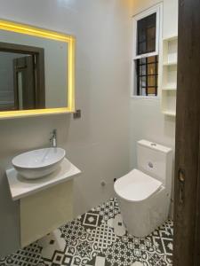 a bathroom with a white toilet and a sink at Zen Studio Apt Lekki 1 in Ilado