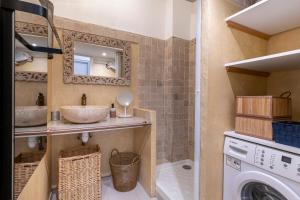 a bathroom with a sink and a washing machine at Monaco Seaview Border - 1bdr flat - 2beds - 4 guests in Beausoleil +9 photos