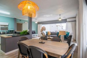 a dining room and living room with a table and chairs at Seaside Apartment Perna Perna Umdloti by First Private Stays in Umdloti
