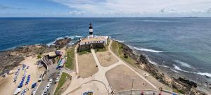an aerial view of a lighthouse on the ocean at COBAR0108 - Edifício Oceania in Salvador