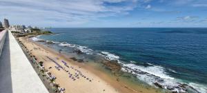 an aerial view of a beach with a crowd of people at COBAR0108 - Edifício Oceania in Salvador