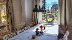 a dining room with a table and a window at Gemütliches Apartment im Grünen mit Kamin und Klöntür in Altenmedingen
