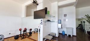 a living room with a tv and some exercise equipment at COBAR0108 - Edifício Oceania in Salvador