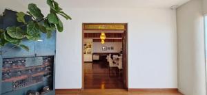 a hallway leading to a dining room with a table at COBAR0108 - Edifício Oceania in Salvador