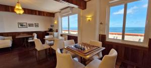a dining room with a table and chairs and the ocean at COBAR0108 - Edifício Oceania in Salvador
