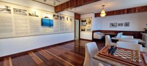 a room with a chess board and a wall with photographs at COBAR0108 - Edifício Oceania in Salvador