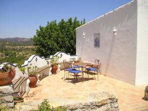 a patio with chairs and a table on a building at Casa da Timenina Privates Rooms in São Brás de Alportel