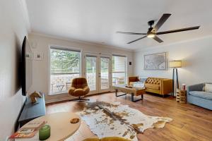a living room with a couch and a table at ‘Lakeside Getaway’ w/ Patio on Lady Bird Lake in Austin