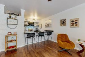 a living room with a kitchen with bar stools at ‘Lakeside Getaway’ w/ Patio on Lady Bird Lake in Austin
