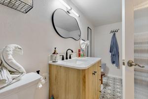 a bathroom with a sink and a mirror on the wall at ‘Lakeside Getaway’ w/ Patio on Lady Bird Lake in Austin +4 photos
