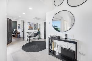 a living room with a fireplace and a mirror at Fairway Sleek Chic in Palm Springs +14 photos
