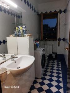 a bathroom with a sink and a washing machine at PUNTO FM Venezia in Venice