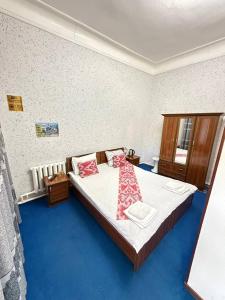 a bedroom with a bed with red pillows on it at World Guest House in Samarkand +111 photos