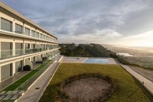 an exterior view of a building with a yard at Casa LukStian in Nazaré