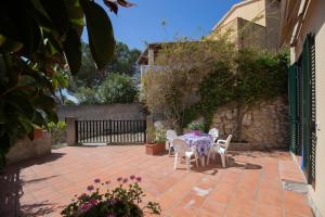 a table and chairs on a brick patio at Capo Bianco Terrace - Helloelba in Portoferraio +28 photos