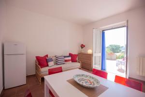 a living room with a couch and a window at Capo Bianco Terrace - Helloelba in Portoferraio