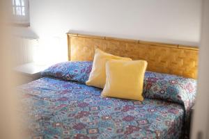 a bedroom with a bed with two pillows on it at Capo Bianco Terrace - Helloelba in Portoferraio