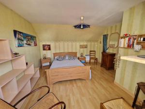 a bedroom with a bed and a table and chairs at chambres évènements circuit LE MANS in La Milesse