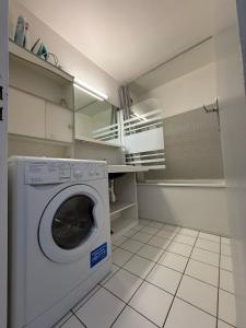 a laundry room with a washing machine in it at Meijotel A N26 - ST5C in Les Deux Alpes