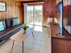 a living room with a couch and a table at Sea Glass Suites 3 in Topsail Beach