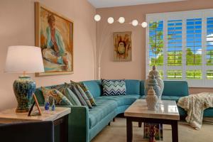 a living room with a blue couch and a table at La Palme Regency in Palm Springs