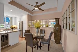 a dining room with a table and chairs and a ceiling fan at La Palme Regency in Palm Springs +17 photos