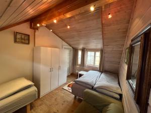 a bedroom with a bed in a room with wooden walls at Knirkenheimen in Trondheim