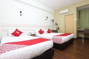 Ένα ή περισσότερα κρεβάτια σε δωμάτιο στο Hotel O Green Mango @ Sri Cemerlang +23 φωτογραφίες