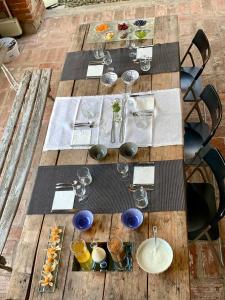 a wooden table with plates and wine glasses on it at Relax in Borgosesia