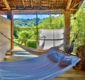a hammock in a room with a view of the mountains at Relax in Borgosesia