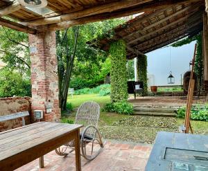 an outdoor patio with a wooden table and a bench at Relax in Borgosesia