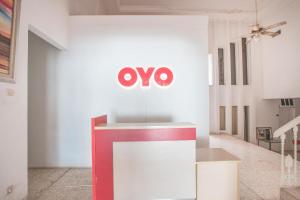 an omo sign on a wall in a room at Capital O 332 Residence G17 Kemang in Jakarta