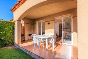 a patio with a white table and chairs on it at Rentalmar Brisas in Miami Platja