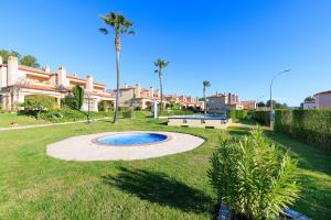 a park with a small pool in the grass at Rentalmar Brisas in Miami Platja
