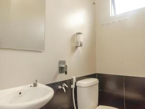a bathroom with a white toilet and a sink at Skudai Hotel in Skudai +43 photos