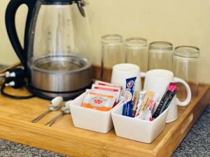 a tray with toothbrushes toothpaste and other items on a counter at Koshoka Suites in Ongwediva