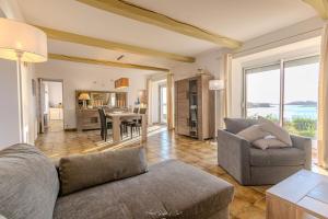 a living room with a couch and a table at Maison pour 7 - Superbe vue mer depuis le jardin in Penvénan +15 photos
