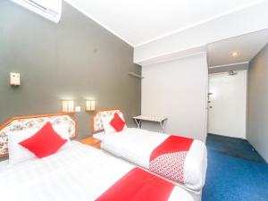Postel nebo postele na pokoji v ubytování Super OYO 1026 Hotel Lutana