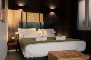 a bedroom with a large bed with two towels on it at Bella Vista Hôtel, Suites & Maisons in Porticcio