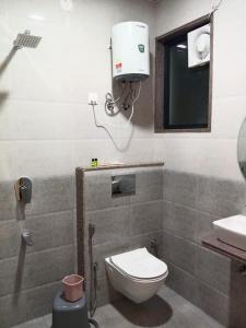 Un baño con un inodoro blanco y un lavabo. en Hotel Mb Nirala Shyam, en Khātu