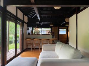 a living room with a white couch and a table at Habuman Okinawa in Kunigami