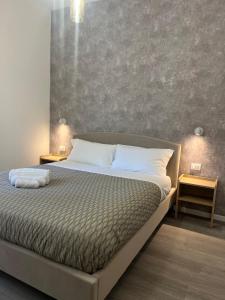 Postel nebo postele na pokoji v ubytování Tiburtina Urban Rooms