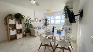 a living room with a table and chairs at Primera linea de playa en Torrox Costa in Torrox Costa