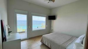a bedroom with a bed and a large window at Enchanting Sea View in Kallithea Halkidikis