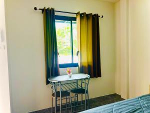 a small table in a room with a window at Palm Tree Hideaway in Ao Nang Beach
